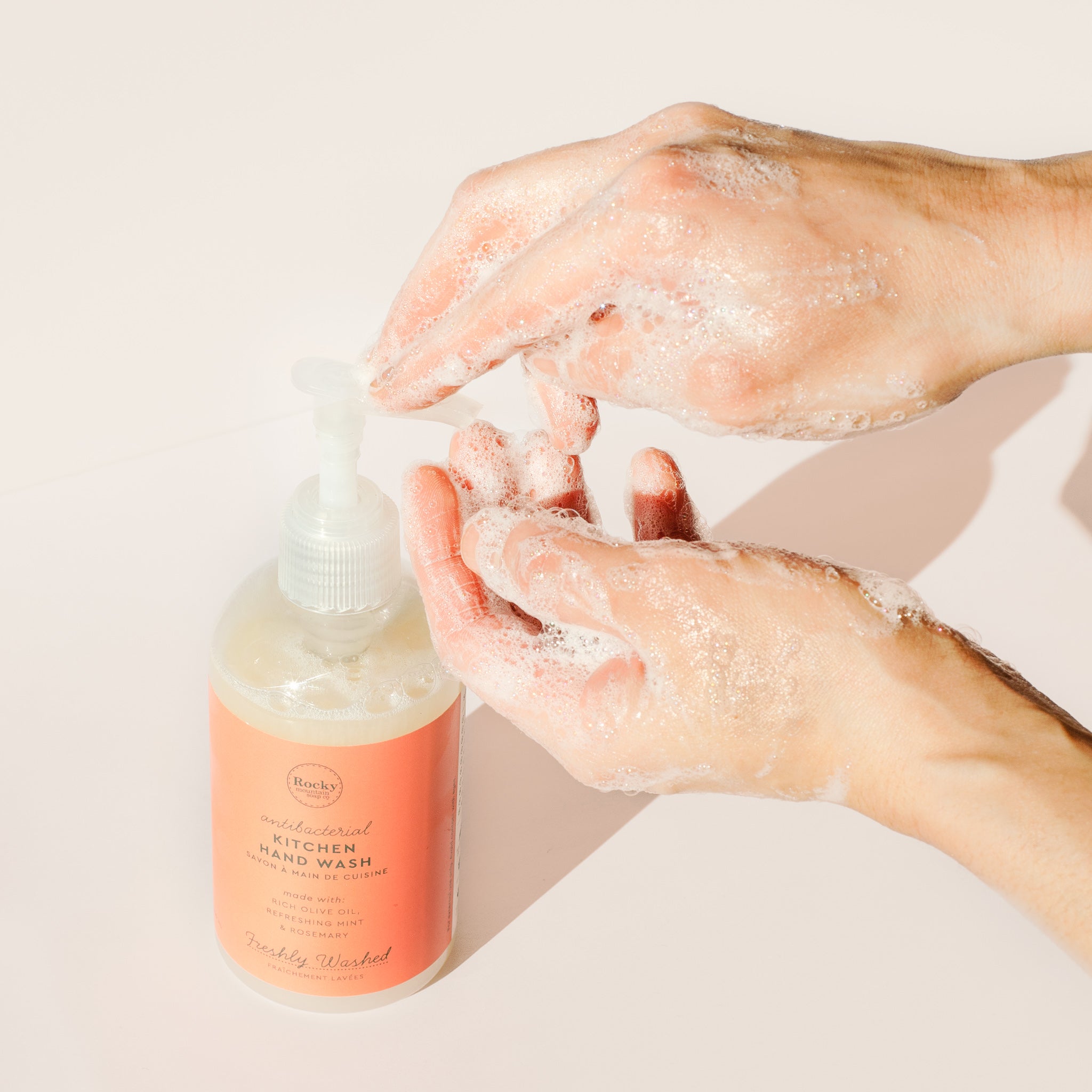 Image of hands washing with lather pumping antibacterial liquid soap from Rocky Mountain Soap Campany Kitchen Hand Wash.  