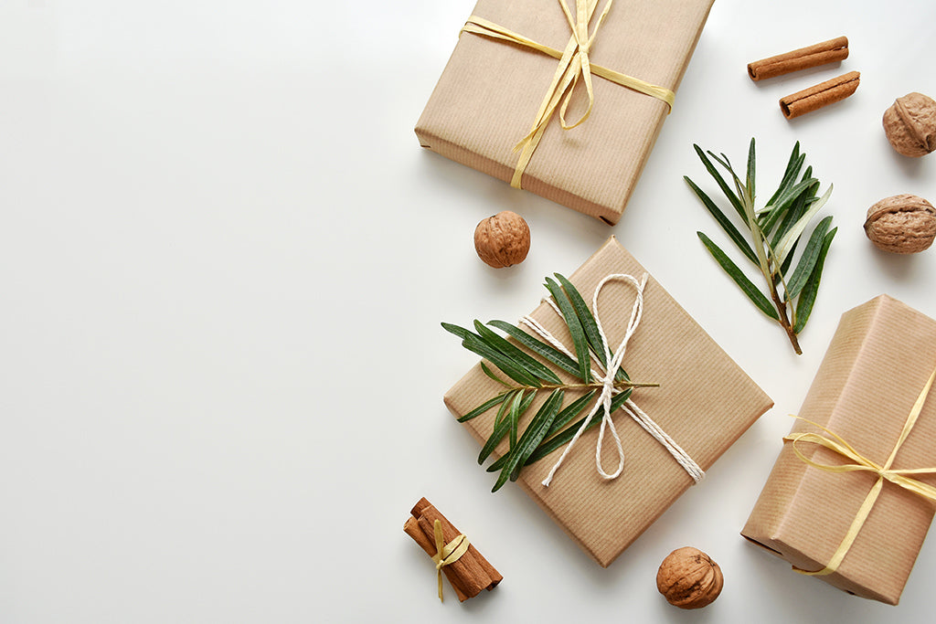 Gifts wrapped in plain brown craft paper are one way of using eco-friendly gift wrapping this season. Reusing interesting paper from around the home like old newspaper or maps are a way to keep less paper from the landfill. 