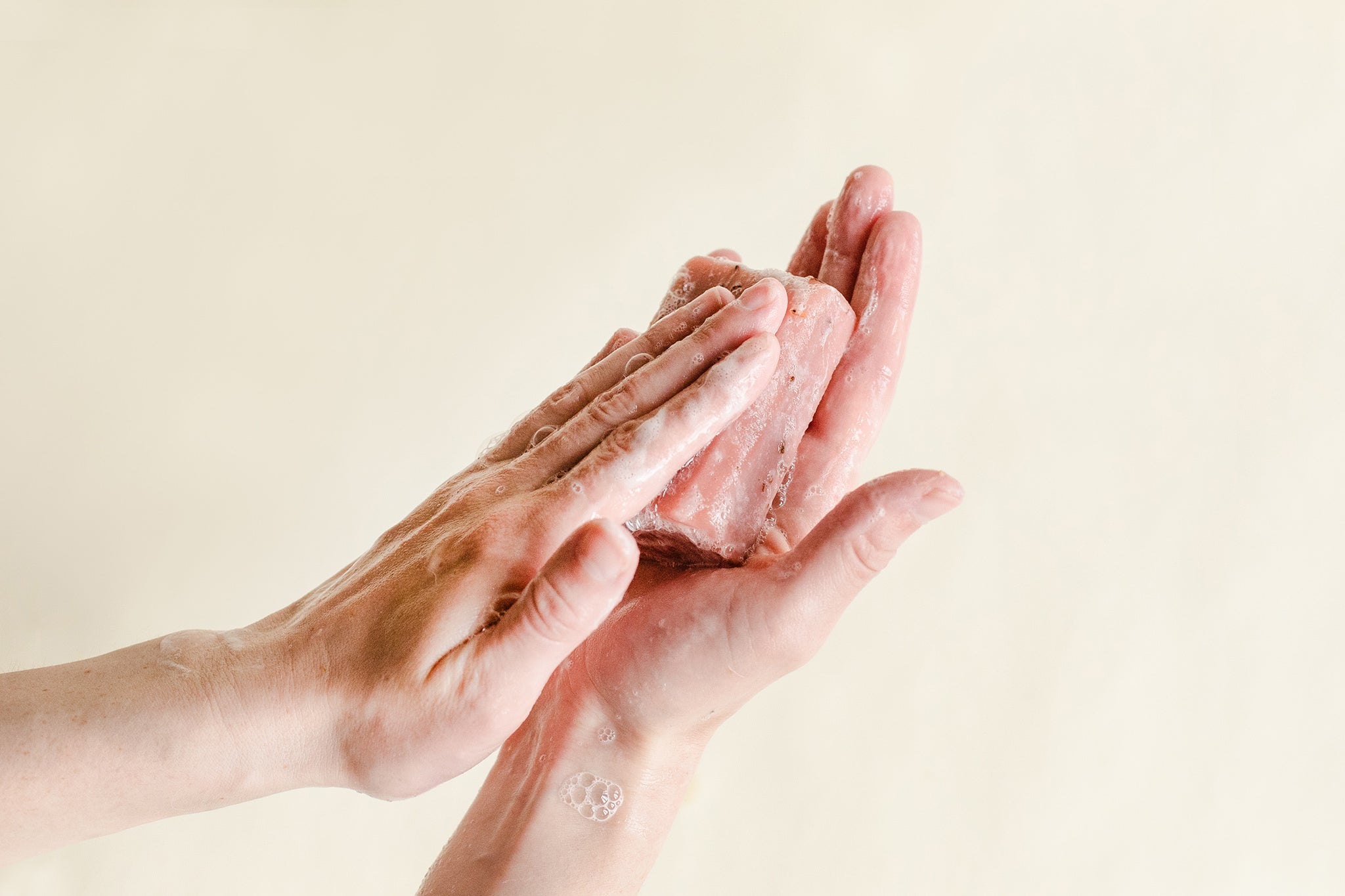 Image of a pair of hands washing with all natural bar soap.