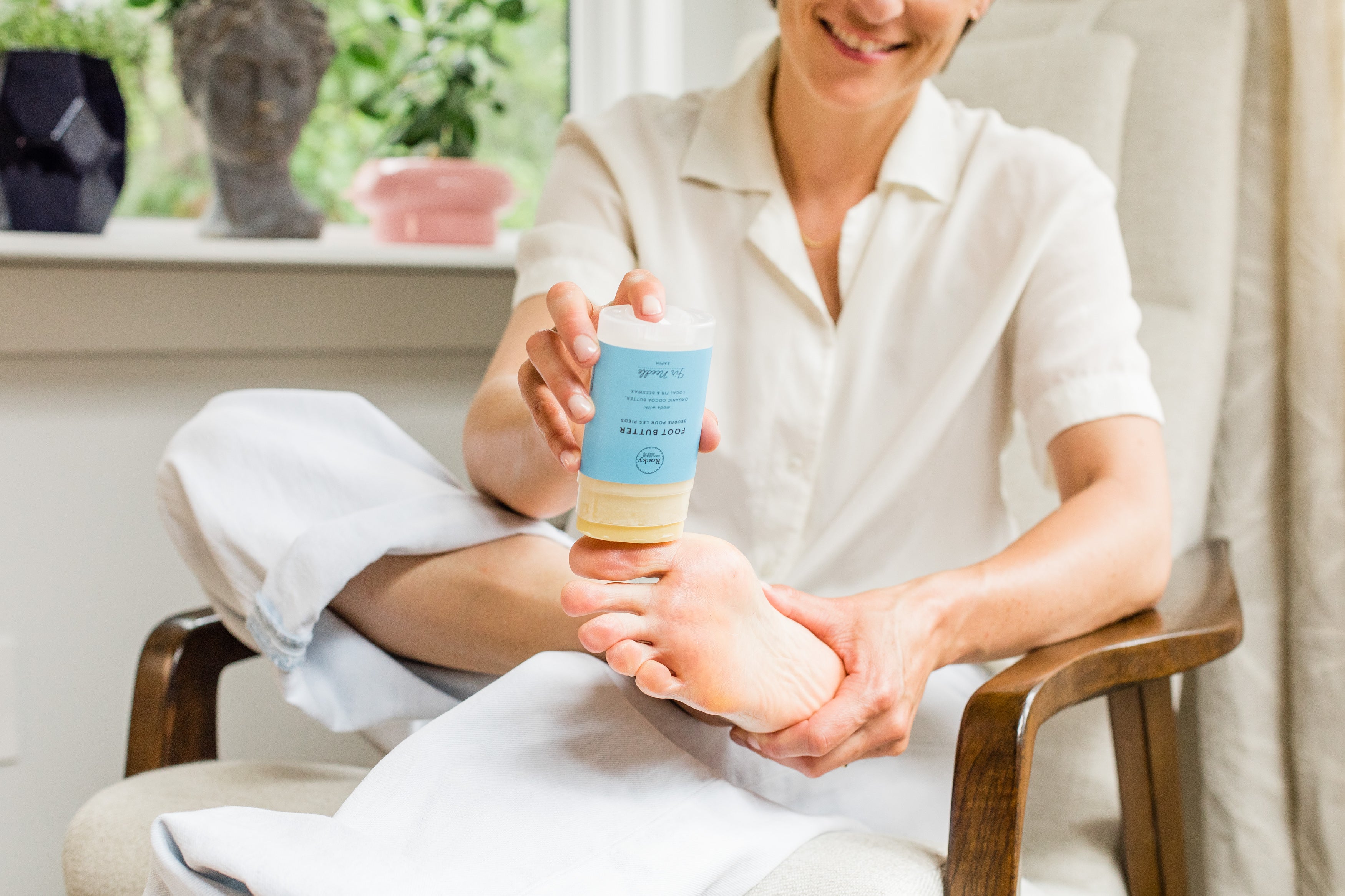 Karina Birch applying Rocky Mountain Soap Company Foot Butter to her foot. 