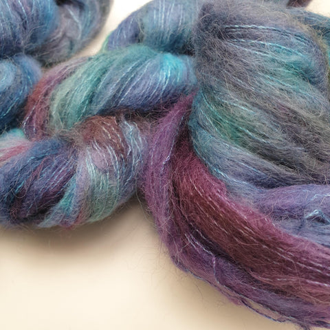 Deep purpley blue and aqua blue tonal on a soft suri silk cloud base.