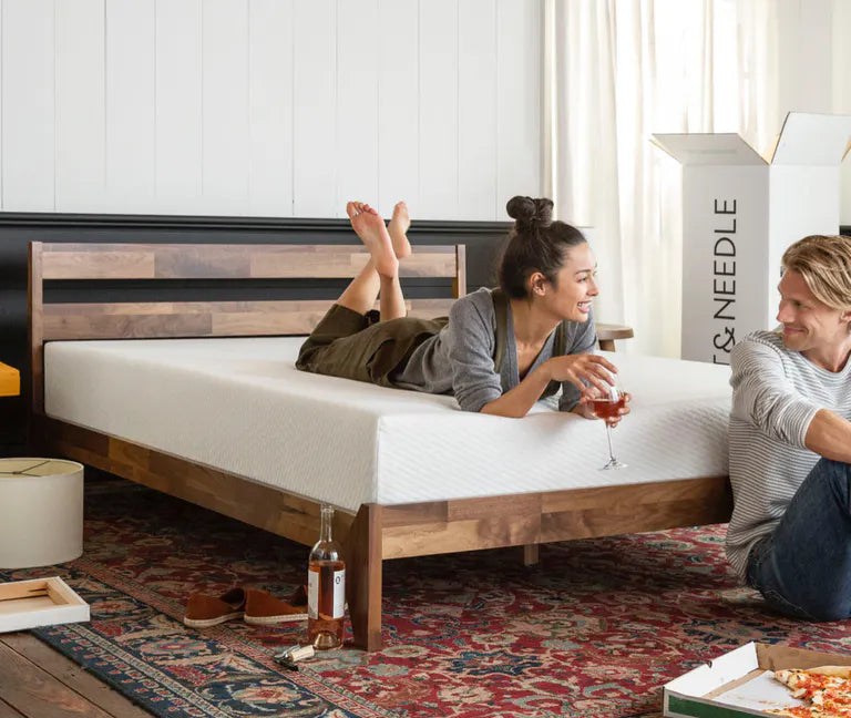 couple relaxing in bedroom next to T&N box