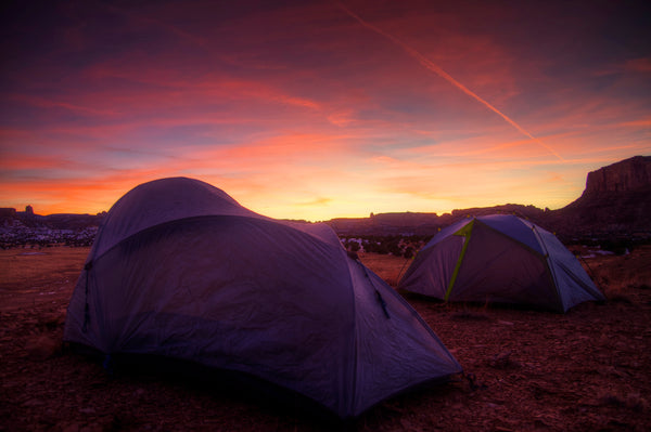 a group of tents overlooking the sunset