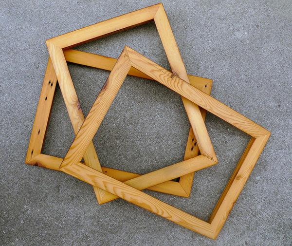 a pile of wooden art frames