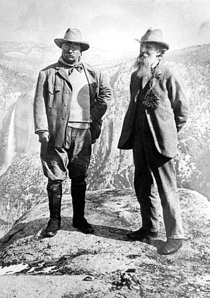 John Muir and Theodore Roosevelt posing on a cliff