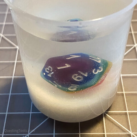 Multicolored dice not floating in salt water.