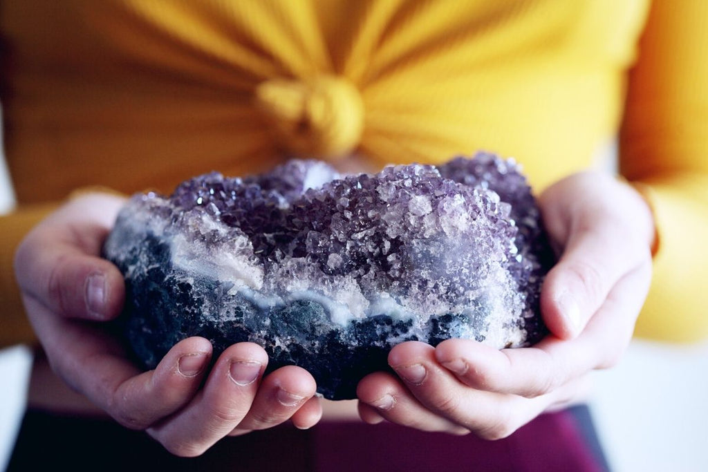 Woman holding amethyst stone