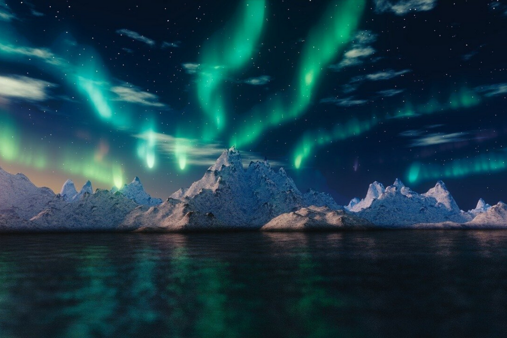 the northern lights above snowy mountains