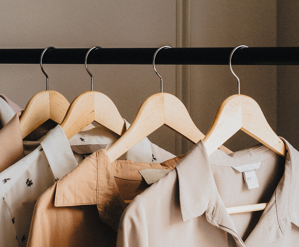 Donated clothes hanging on clothes rack