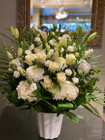 white tribute flower arrangement in mache