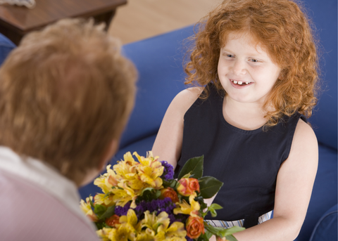 father giving flowers to daughter