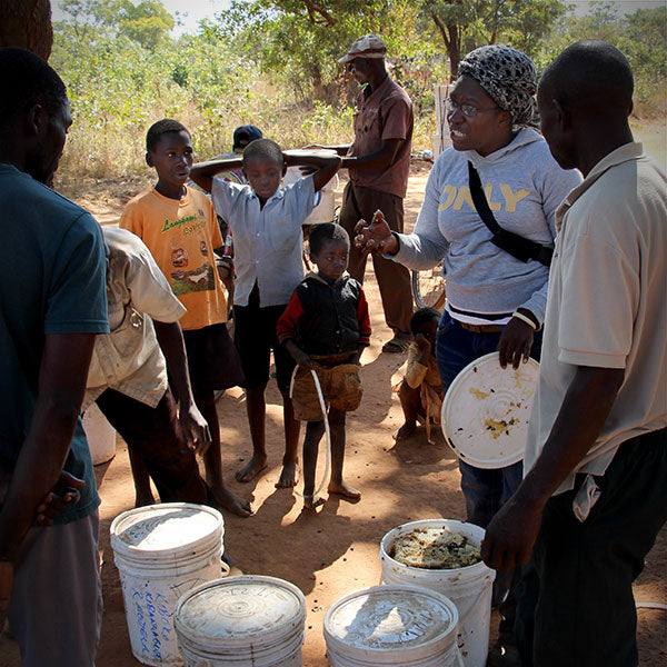 Zambian beekeepers and children