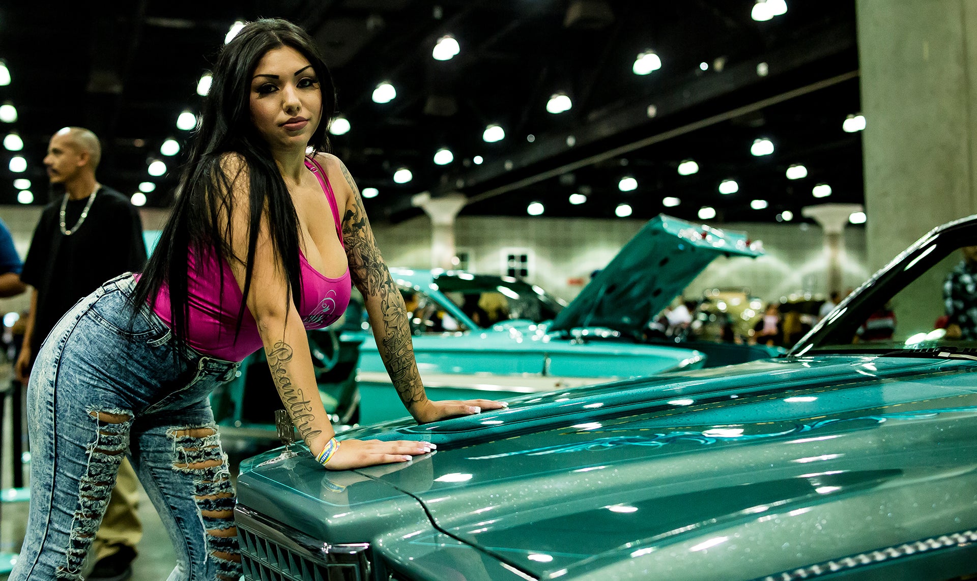 Beautiful lady posing next to a car