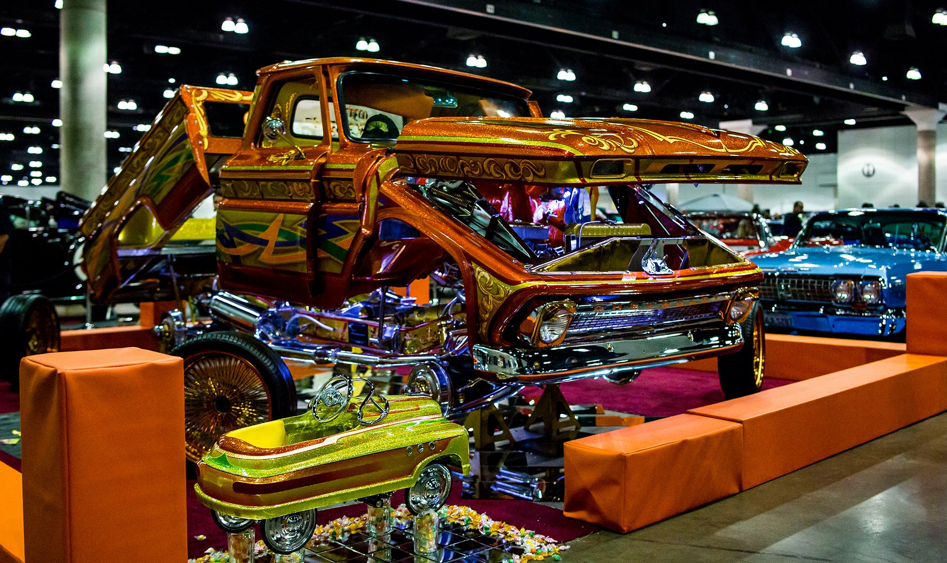 lowrider truck posted next to matching toy truck