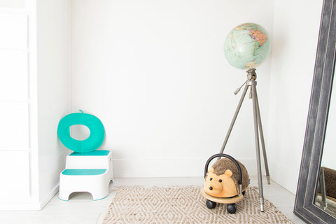 A bathroom with a potty seat and step stool