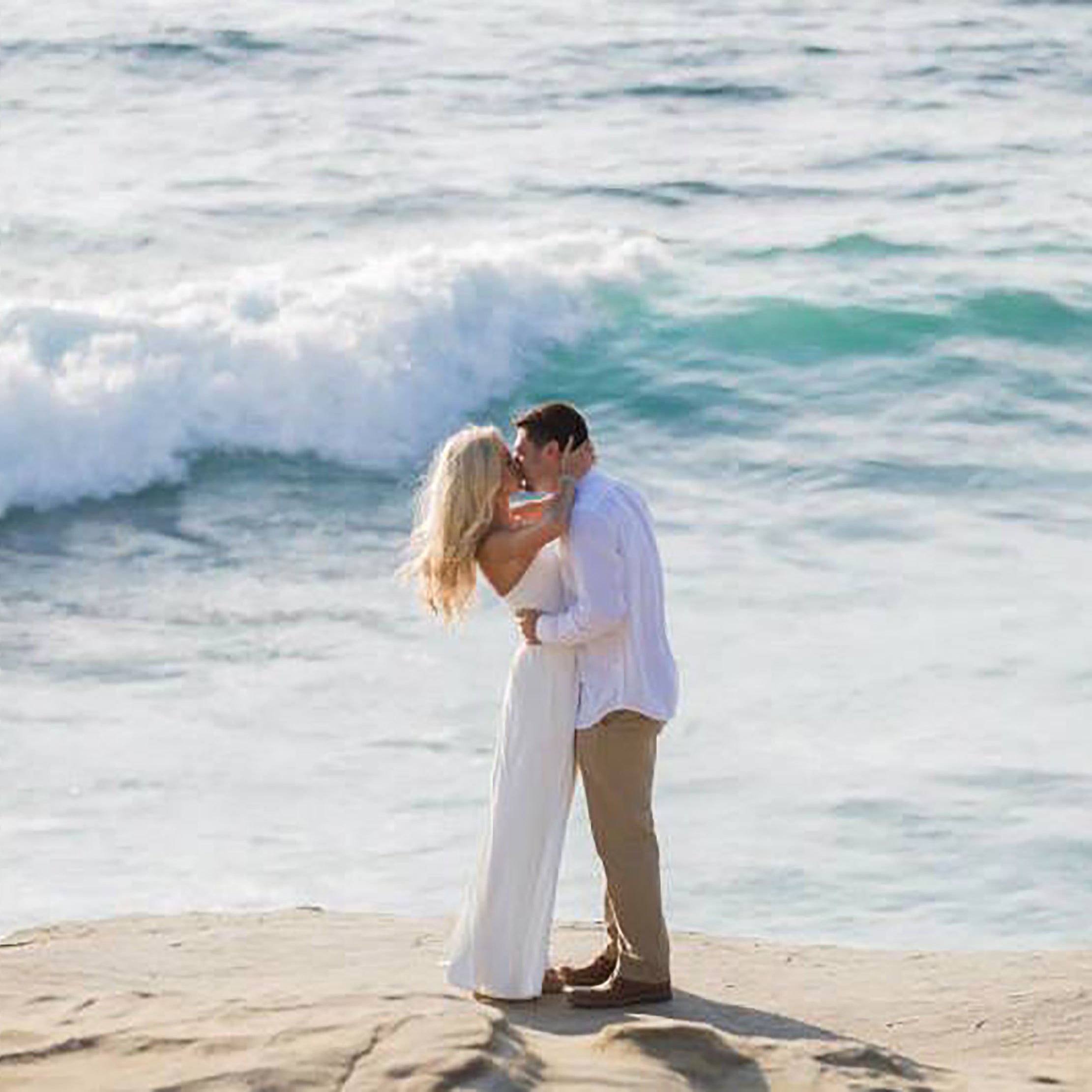 beach proposal waves crashing kiss