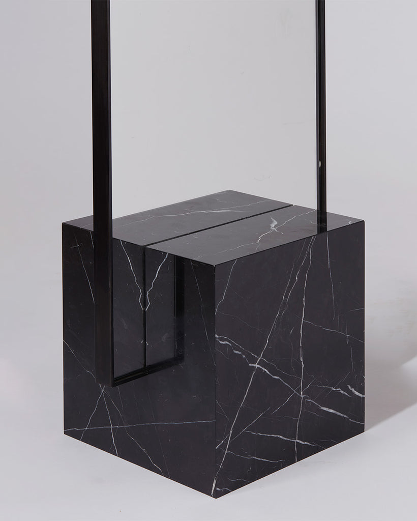 Cube base detail image of standing mirror with nero marquina marble base and blackened steel mirror frame.