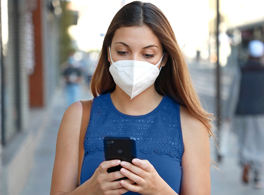 Woman texting | KN95 Face Masks | Best masks