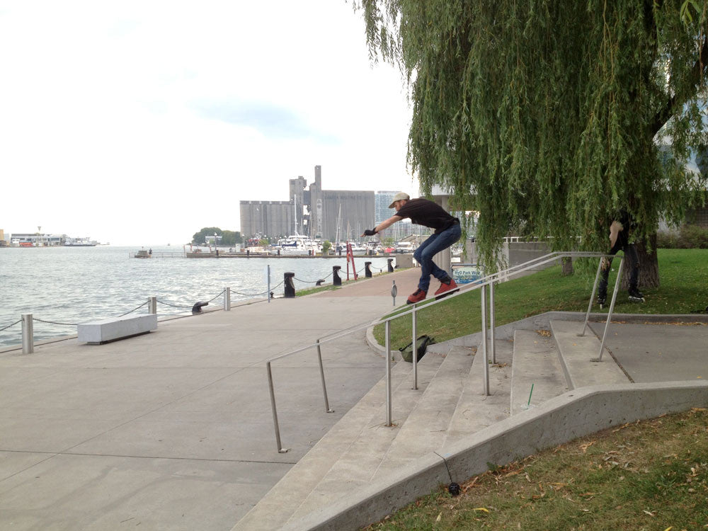 Erik Burrow inline skating down a handrail at HTO Park West in Toronto