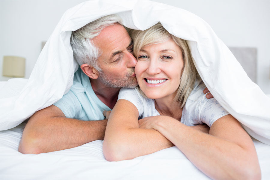 older couple under sheets in bed, erectile dysfunction story