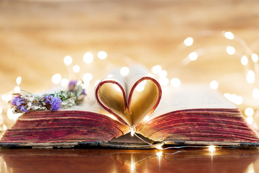 book with pages in shape of heart, flowers, lights, romantic poetry