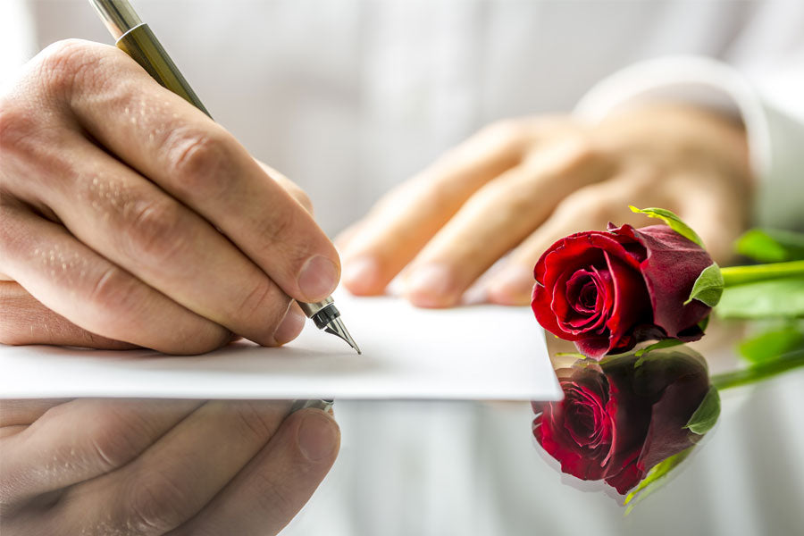 Man writing sex note with rose