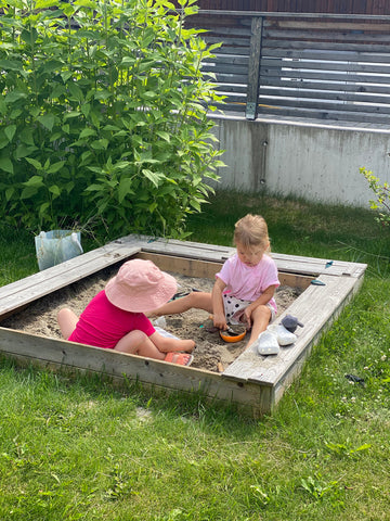 Sofie and Ella playing in sandbox in norway