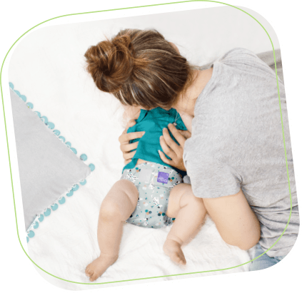 Step 3 nappy change image showing baby on a change mat Step 3 nappy change image showing baby on a change mat