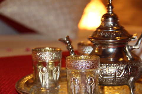 two frosted glass and a silver teapot