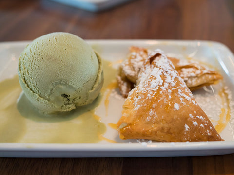 closeup of green ice cream and dessert on plate