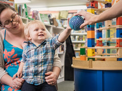 Child passing a ball to someone