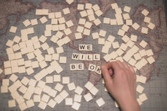 Scrabble tiles spelling "We Will Be Okay"