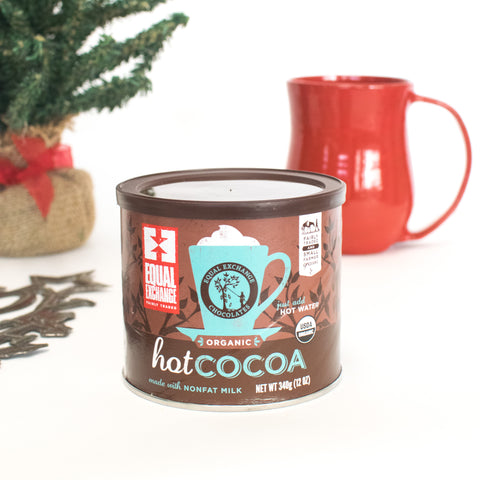hot chocolate container with red mug in the background