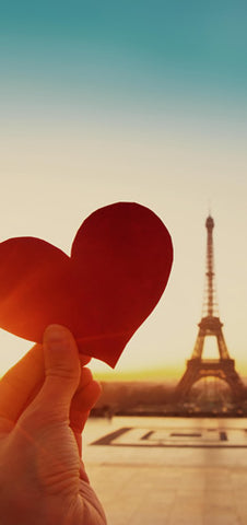A paper heart in front of the Eiffel Tower in Paris, France.