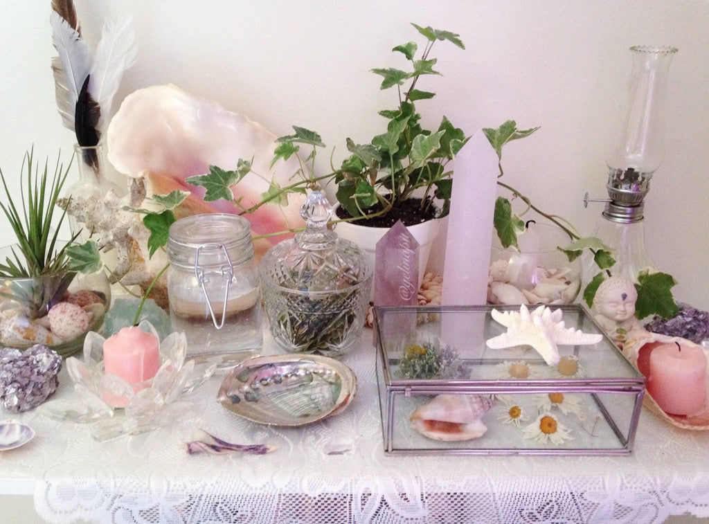 a picture of a pink toned witch altar