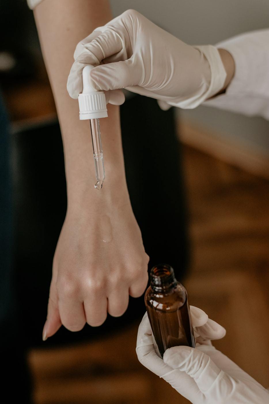 picture of a woman applying essential oils and cosmetics to another woman's hand