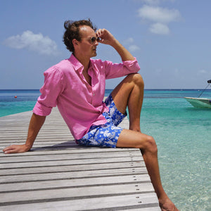 Mens designer swim trunks : MERMAID - NAVY sitting on the pontoon Mustique