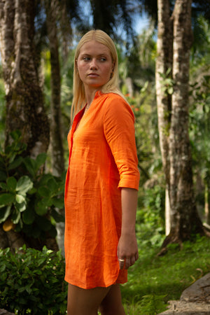 Tropical vacation style women's Decima dress in orange pure linen by Lotty B Mustique resortwear