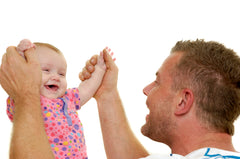 Father playing with toddler Daughter arms held high