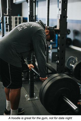 Man wearing a hoodie in the gym