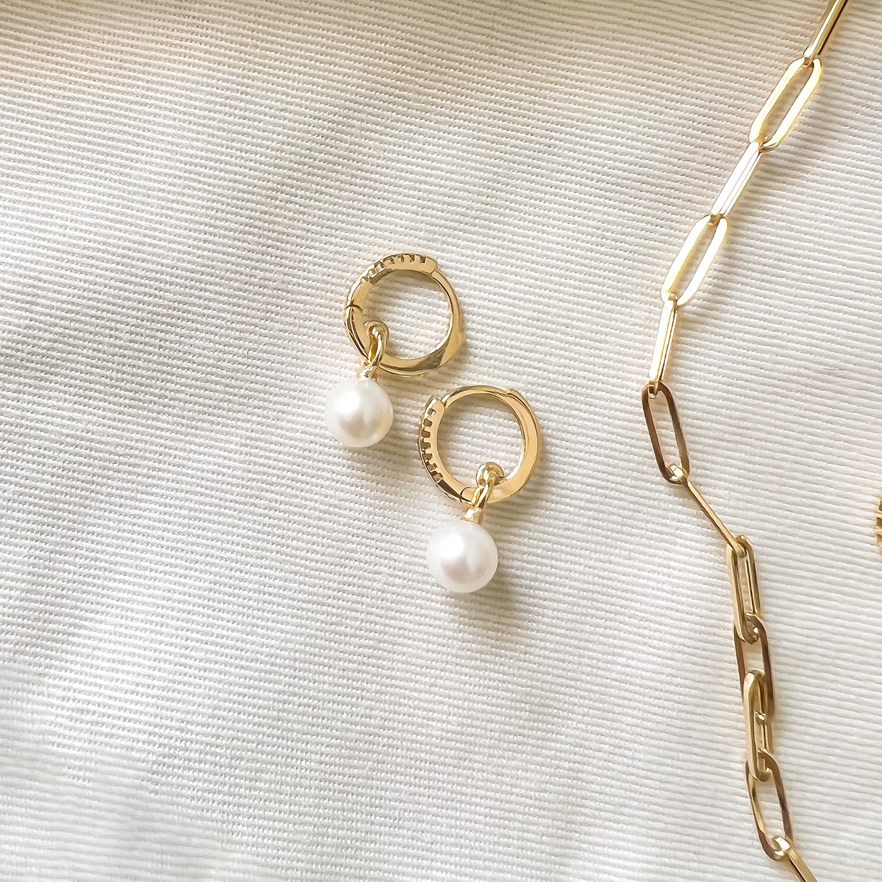 Pearl Drop Hoop | 
                    18-karat gold and cultured pearls.