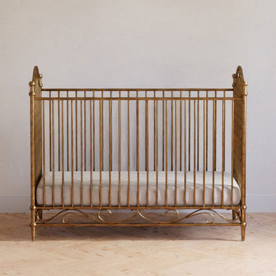 Front view of Namesake's Camellia 3-in-1 Convertible Crib in a room in -- Color_Vintage Gold