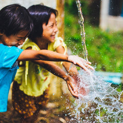 Children Enjoying Clean, Flowing Water