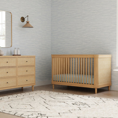 Namesake's Marin 6 Drawer Dresser next to a crib in -- Color_Honey/Honey Cane