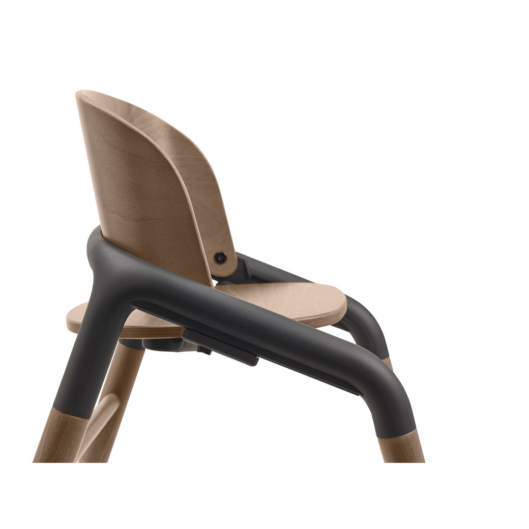 Side view closeup of Bugaboo Giraffe High Chair in --Color_Warm Wood / Grey