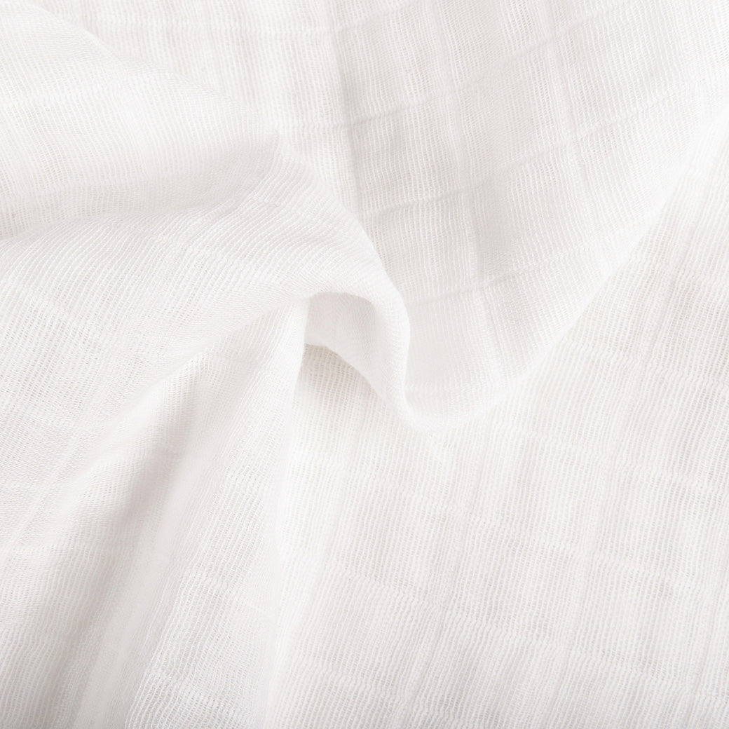 Crinkled closeup of the All-Stages Bassinet Sheet In GOTS Certified Organic Muslin Cotton in -- Color_White