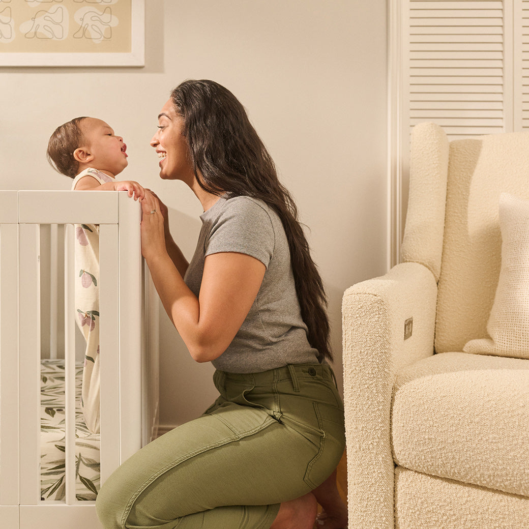 Baby and mother with the Babyletto's Yuzu 8-In-1 Convertible Crib in -- Color_White