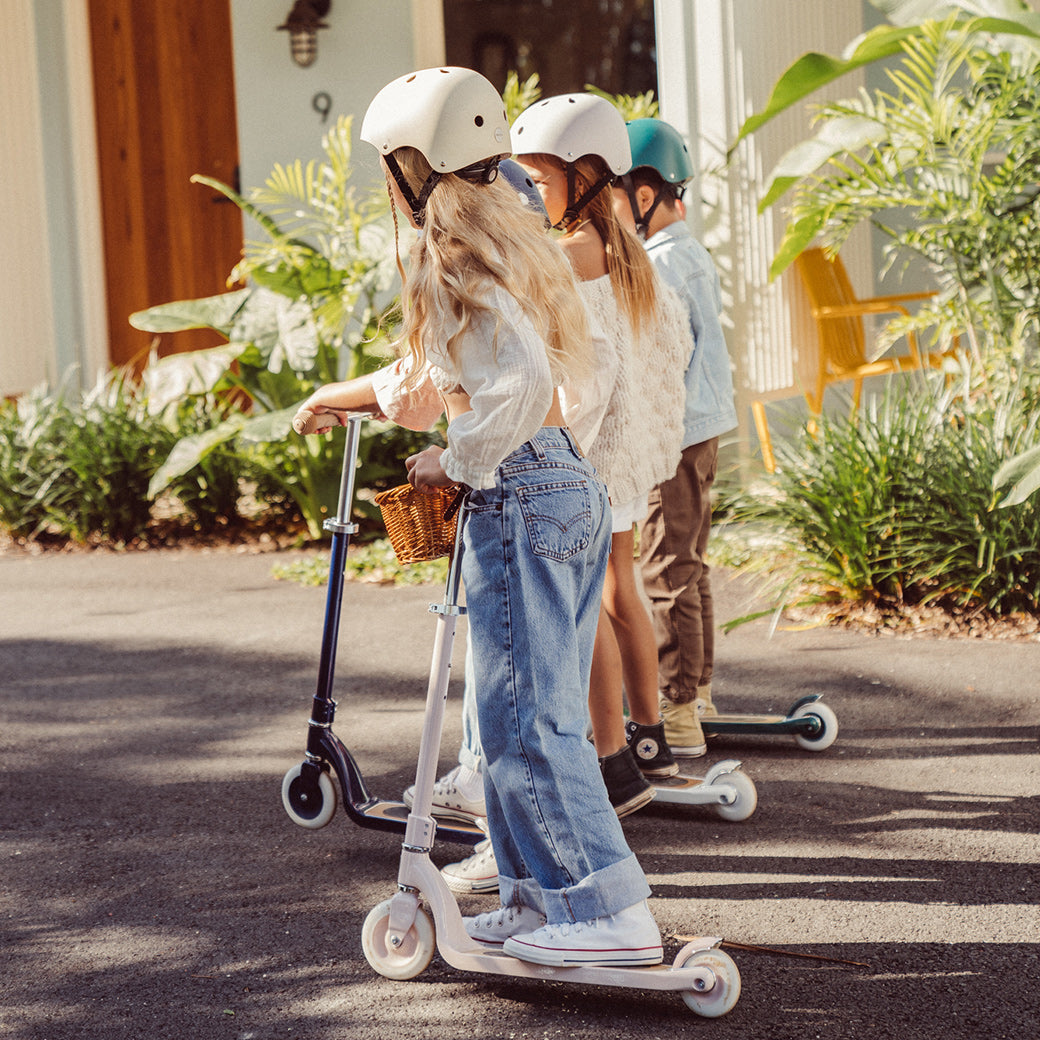 Three children riding Banwood Maxi Scooters in -- All