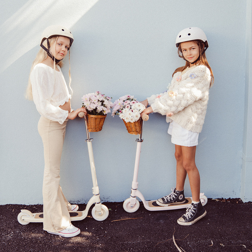 Two girls with beloved wicker baskets riding Banwood Maxi Scooters in -- All