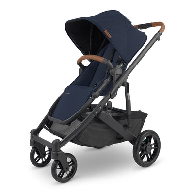 UPPAbaby CRUZ V2 Stroller, angled slightly to the left with black frame and navy blue fabric -- Color_Noa